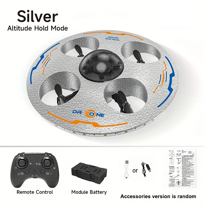 Silver UFO drone shown with a remote control, modular battery, charging cable and instructions