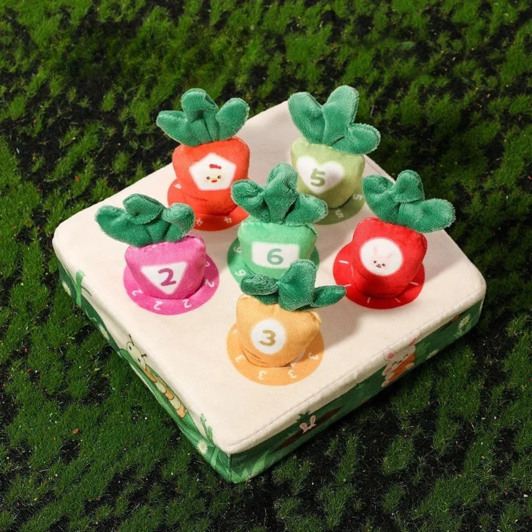 Six numbered plush carrots seated in a square garden board