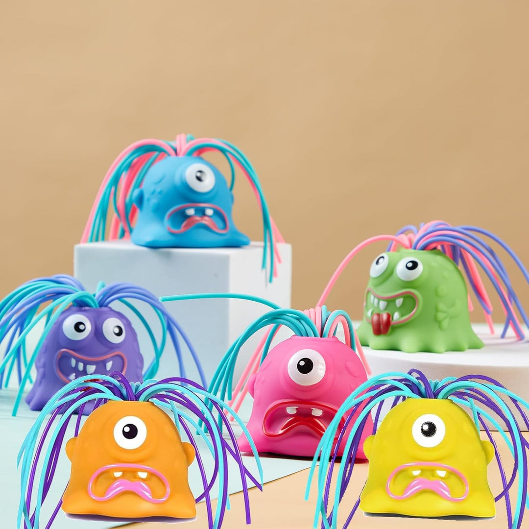 Six colorful monster stress toys with long strands of hair arranged on display blocks