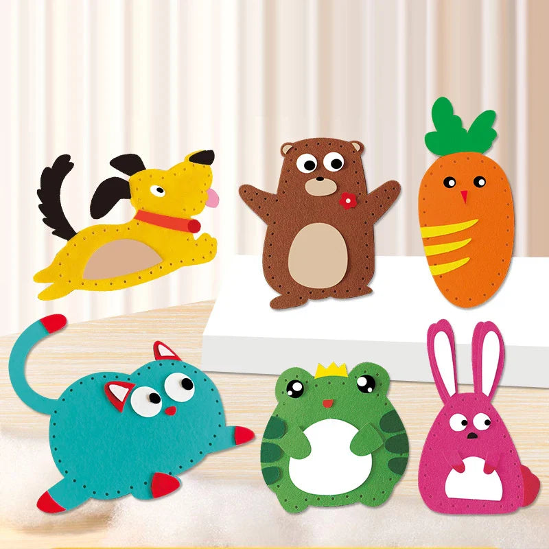 Finished felt dog, bear, carrot, cat, frog and rabbit displayed together