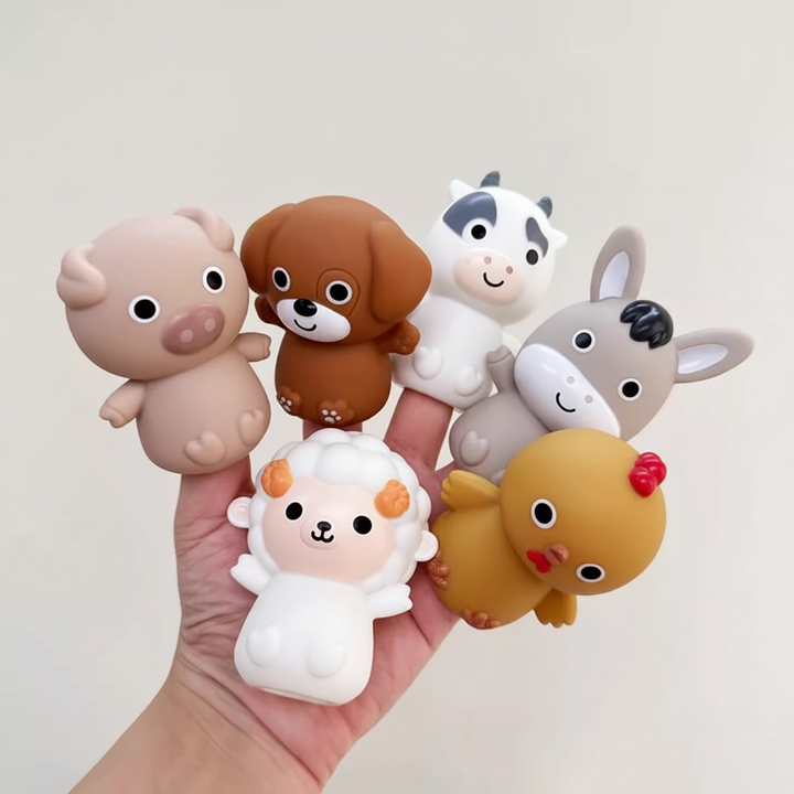 Hand holding soft pig, dog, cow, horse, sheep and chick figures