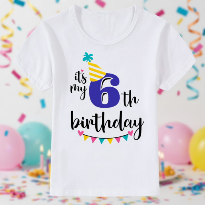White sixth-birthday T-shirt with a blue number 6, yellow party hat, and colorful bunting