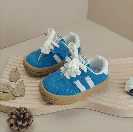 Sky blue lace-up sneakers with white side stripes, pale linings and gum-colored soles