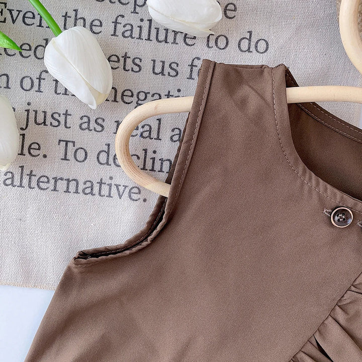 Armhole stitching and shoulder detail on the brown sleeveless cotton top