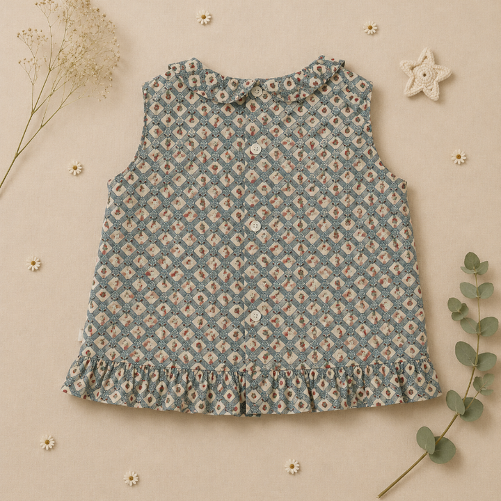 Sleeveless daisy-print blouse with a ruffled hem laid flat