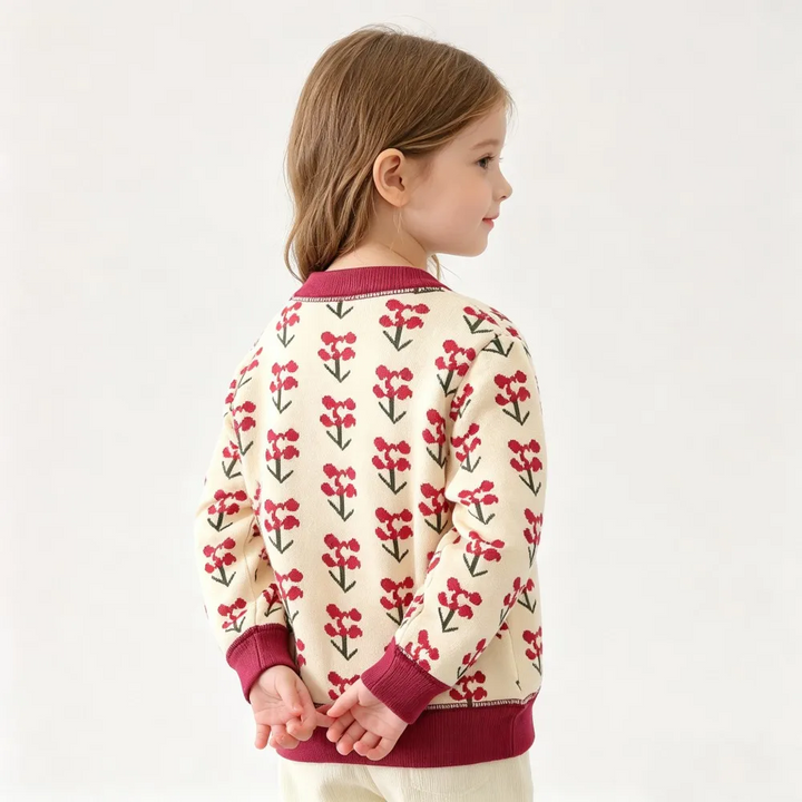 Back view of a cream cardigan with small red flowers and a burgundy ribbed hem