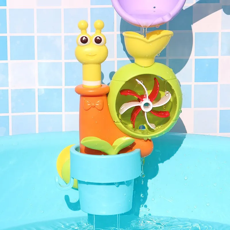 Purple scoop pouring water into the snail bath toy above its green wheel