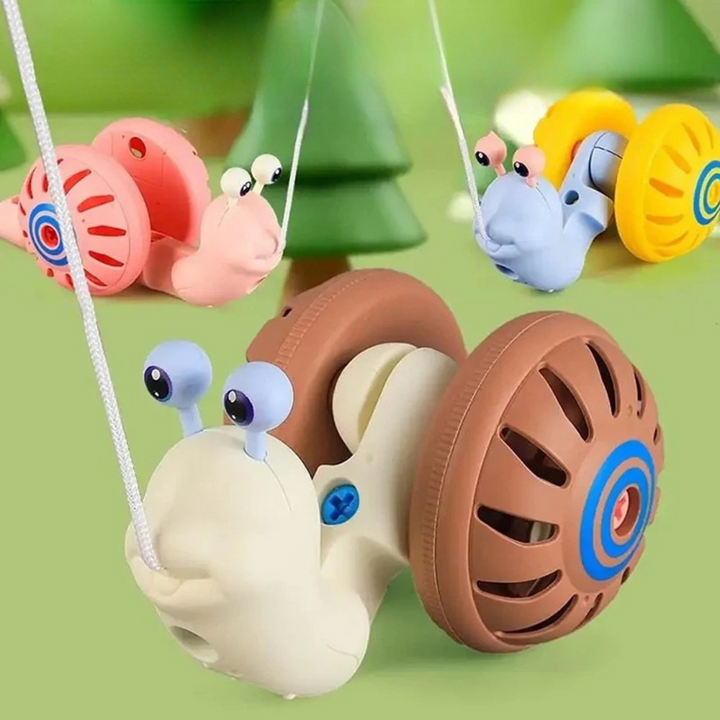 Brown snail pull toy in front of pink and blue snail toys
