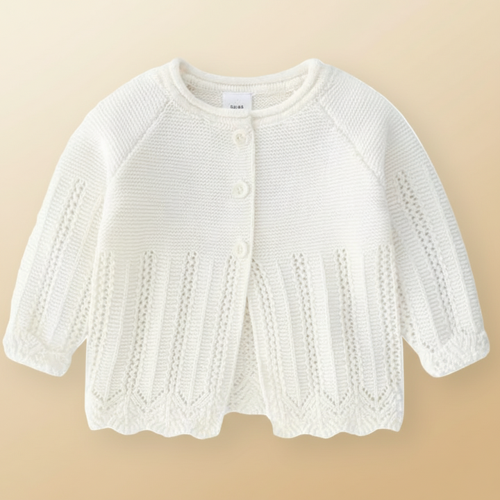 Snow white baby cardigan with openwork knit details and a scalloped hem