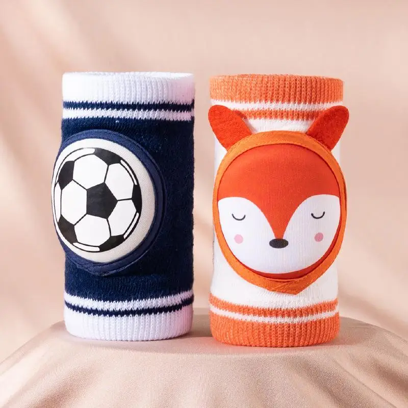 Navy soccer knee pad beside an orange-and-white fox knee pad.