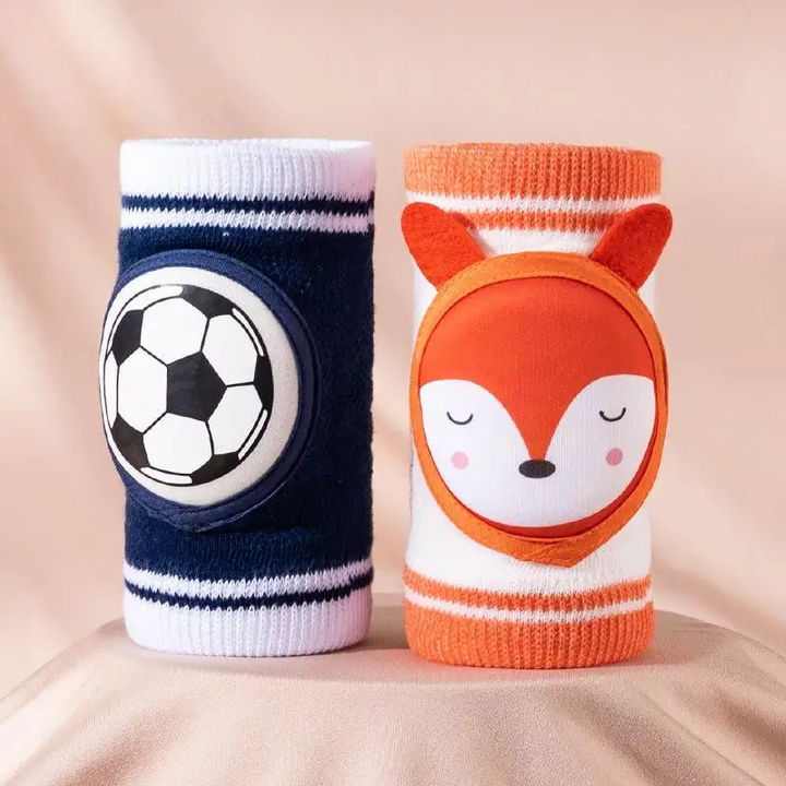 Navy soccer knee pad beside an orange-and-white fox knee pad.
