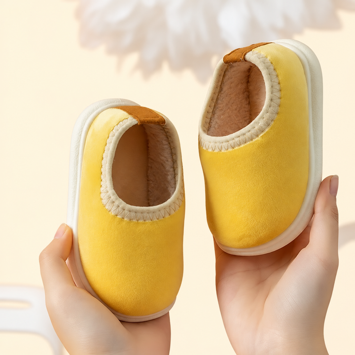 Soft yellow slip-on slippers with cream-colored trim and white soles