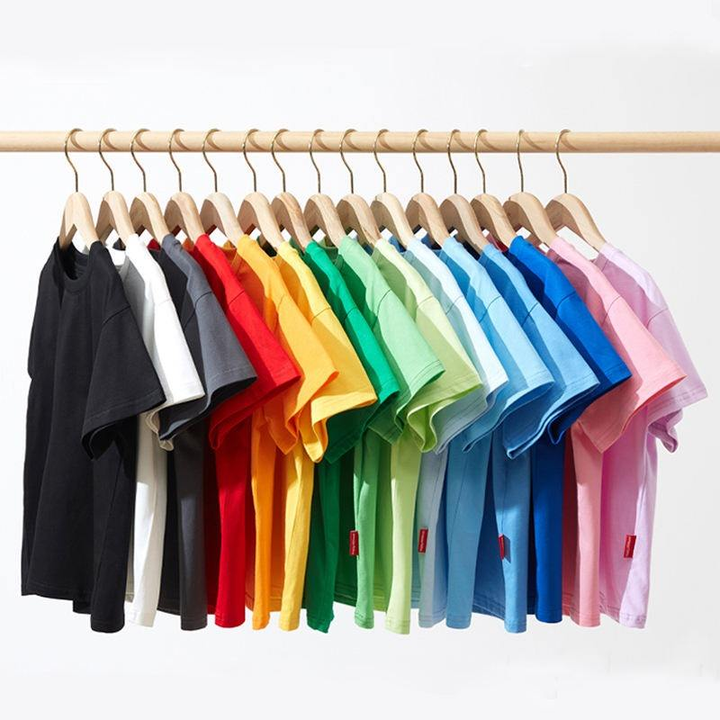 Short-sleeve T-shirts in a range of solid colors on wooden hangers