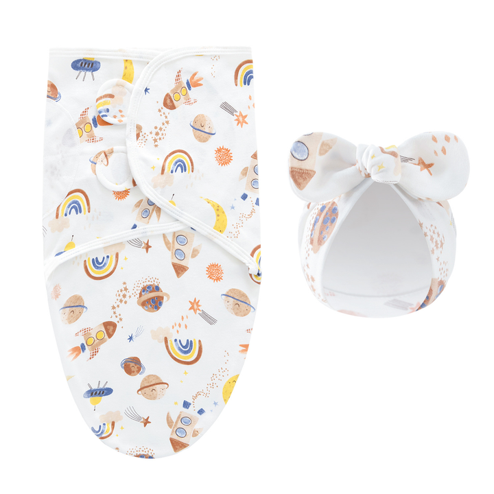 White swaddle blanket and matching bow hat with rockets, planets, and rainbows