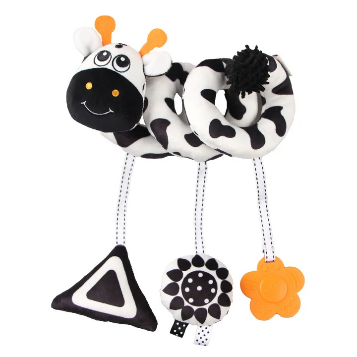 Black-and-white spotted animal spiral toy with a hanging triangle, patterned circle, and orange flower.