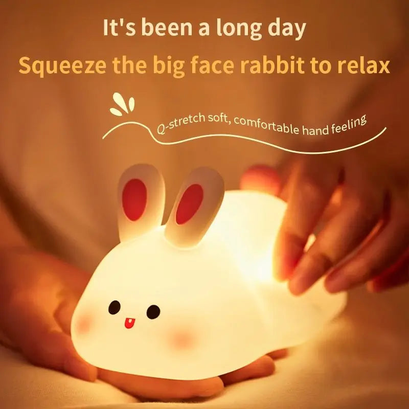 Hands squeezing a softly glowing bunny night light