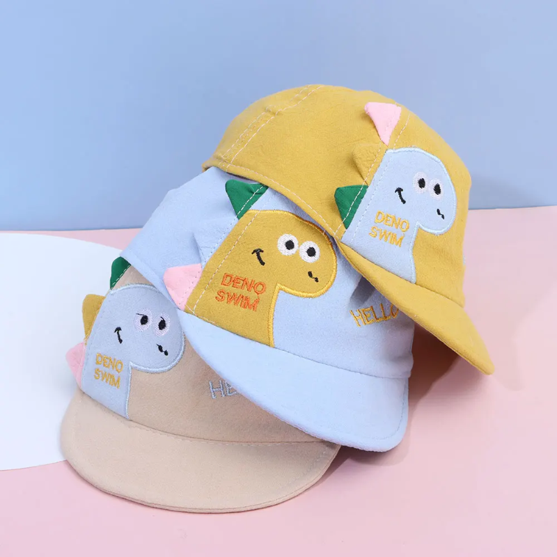 Stacked dinosaur caps showing smiling appliques and colorful fabric spikes.