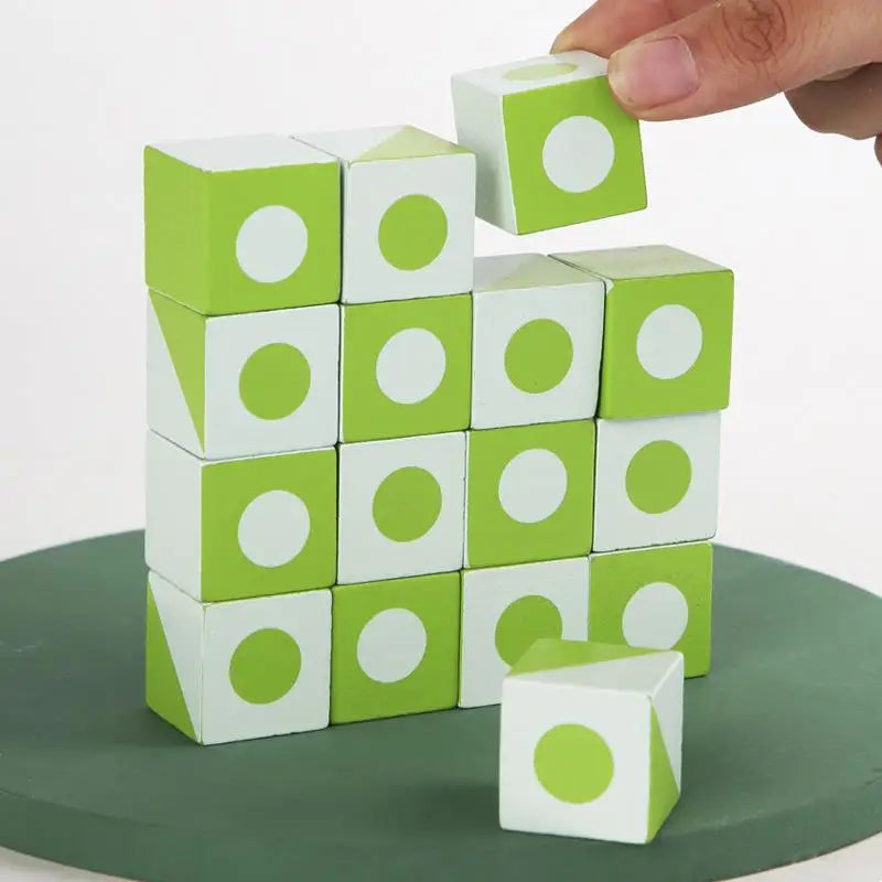 Hand stacking green and white wooden cubes with circle and triangle designs