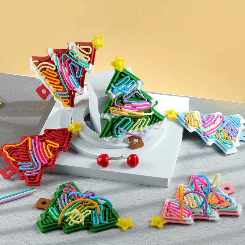 Assorted star-topped Christmas tree fidgets with colorful cords on display
