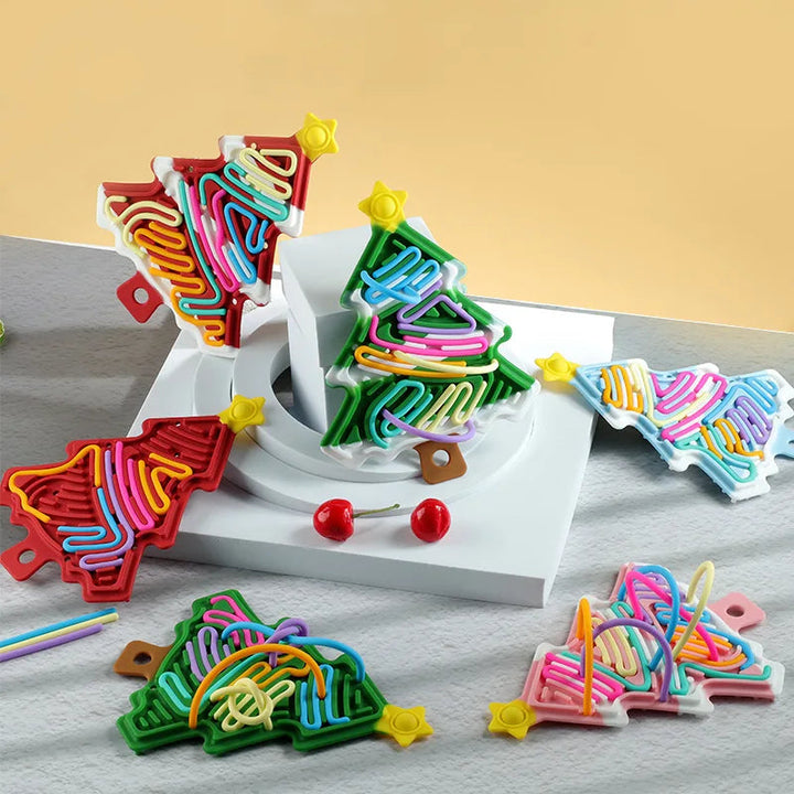 Assorted star-topped Christmas tree fidgets with colorful cords on display