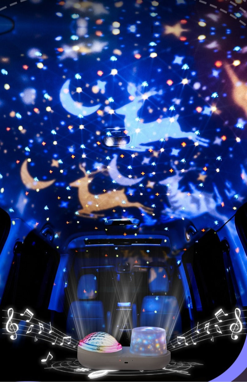 View of a car cabin filled with moon, deer, and star projections from a dual-lens night light.