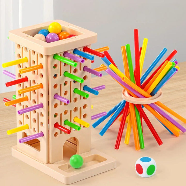 Beige stick-pulling tower with colored balls, hollow sticks, a circular ring, and a color-coded die