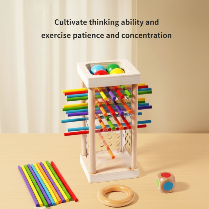 Wooden stick tower, loose colored sticks, a wooden ring, and a die arranged for tabletop play.
