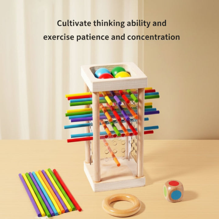 Wooden stick tower, loose colored sticks, a wooden ring, and a die arranged for tabletop play.