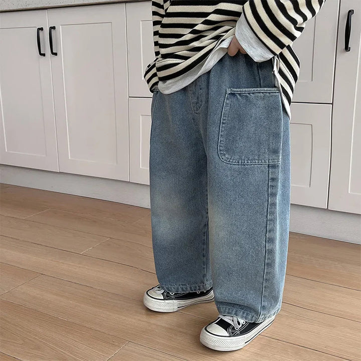 Blue straight-leg jeans styled with a striped shirt and black sneakers