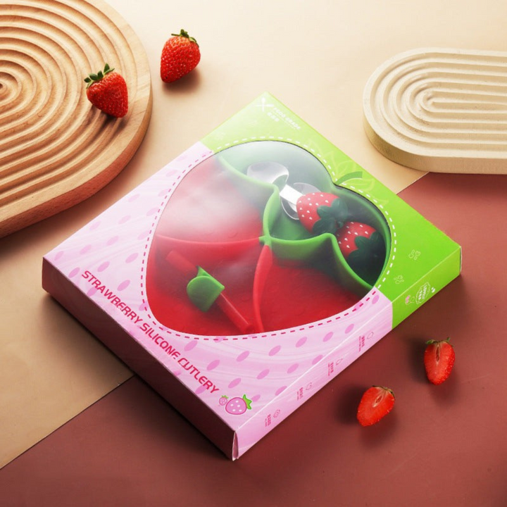 Strawberry-shaped plate and matching cutlery displayed in pink-and-green packaging
