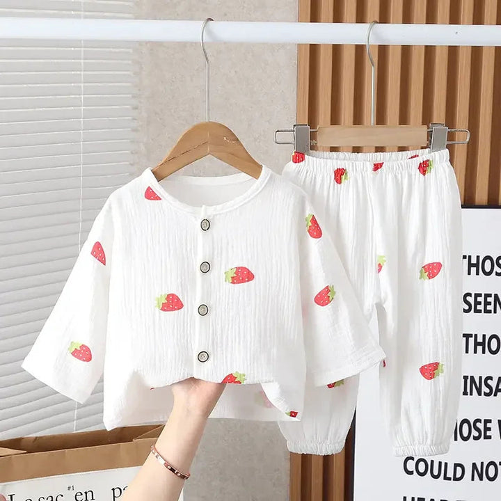 White strawberry-print pajama set with a button-front top and gathered pant cuffs