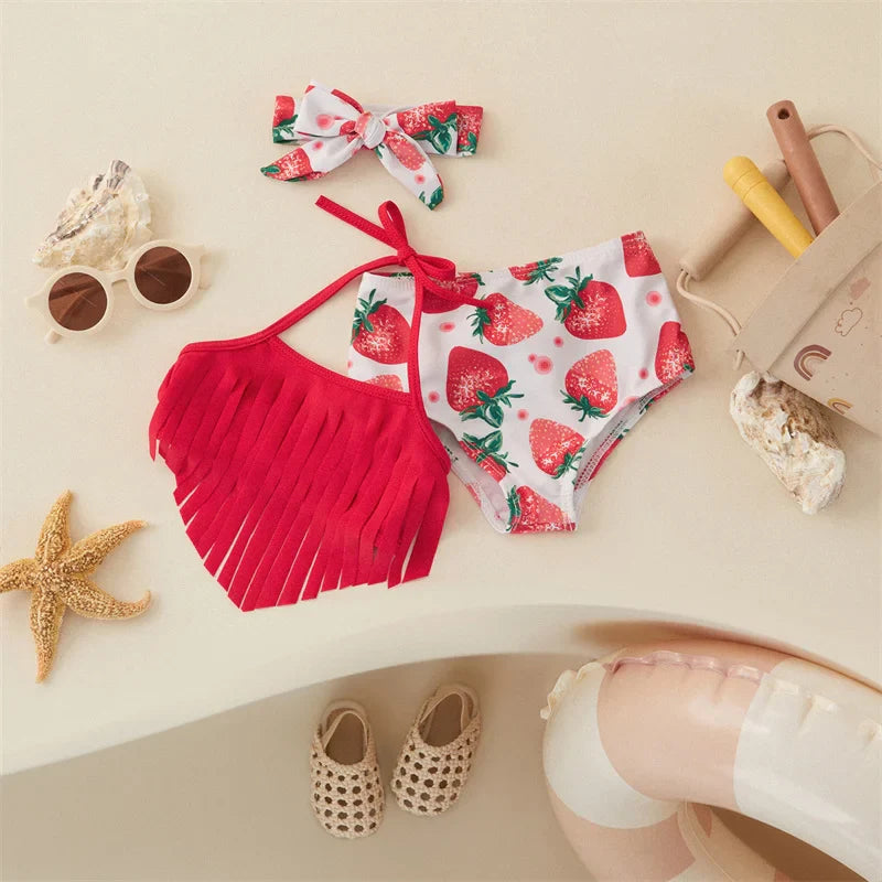 Red halter bikini with a fringed top, strawberry-print bottoms and a matching bow hairband