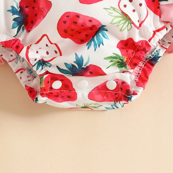Snap closures at the bottom of the strawberry-print baby romper