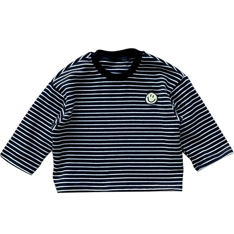 Front view of a black long-sleeve shirt with thin white stripes and a smile patch.
