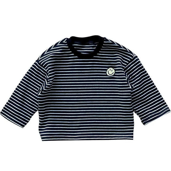 Front view of a black long-sleeve shirt with thin white stripes and a smile patch.