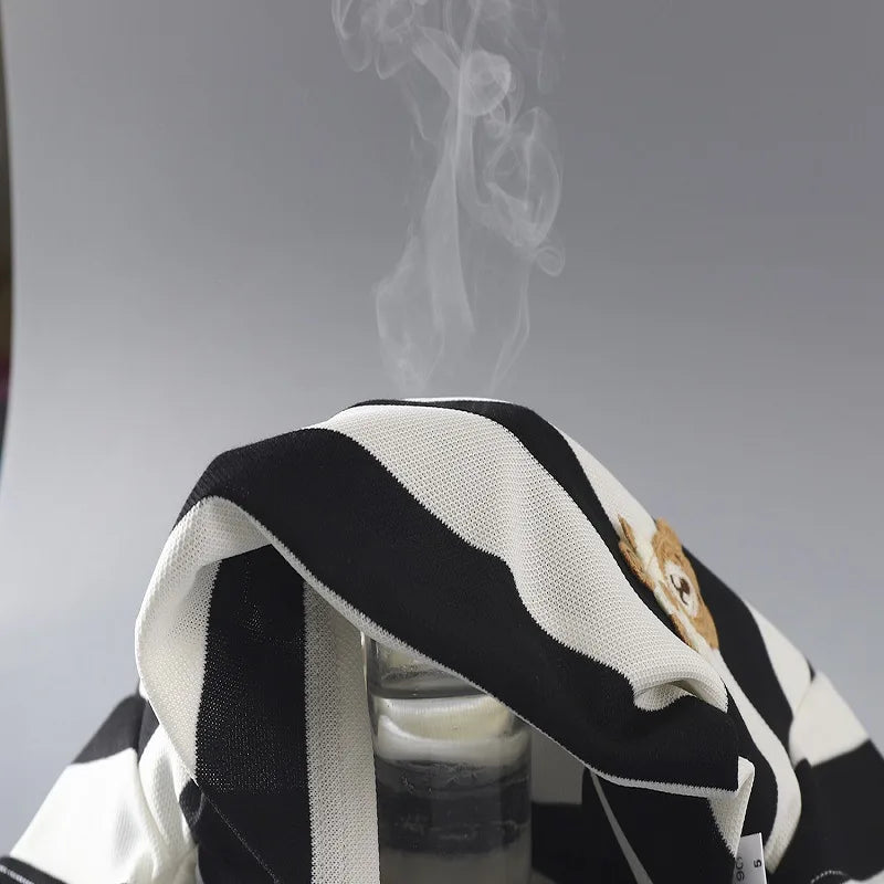 Black-and-cream striped cotton fabric draped over a container with vapor rising above it