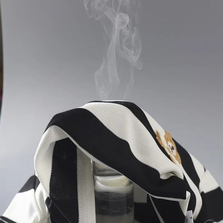 Black-and-cream striped cotton fabric draped over a container with vapor rising above it