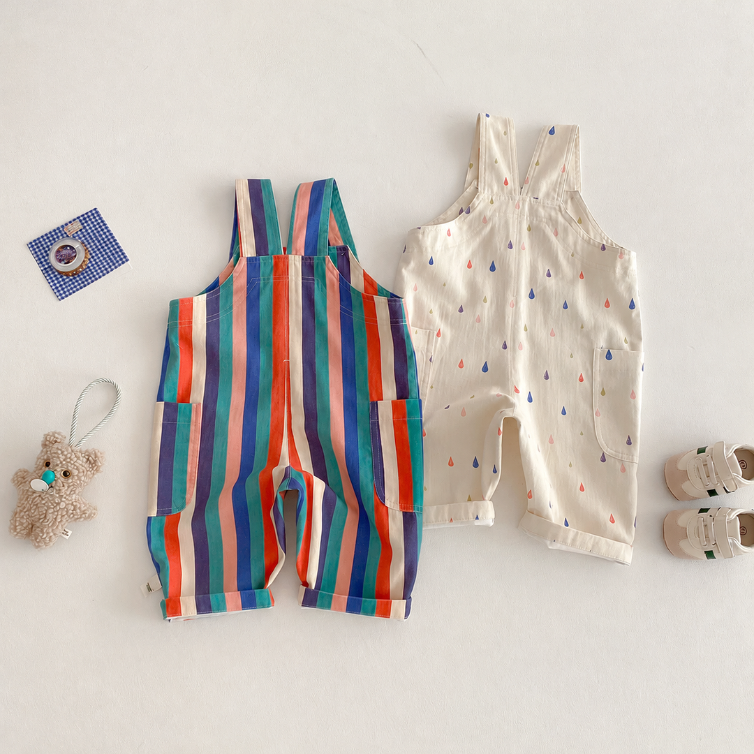 Back view of striped and cream raindrop-print long overalls laid side by side