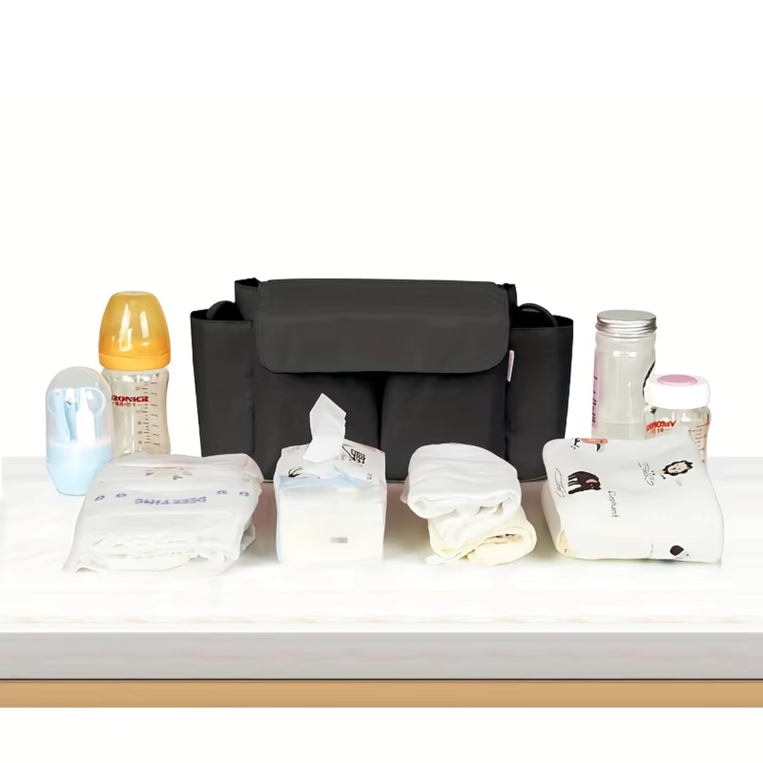 Black stroller organizer displayed with bottles, wipes, diapers, and other baby essentials