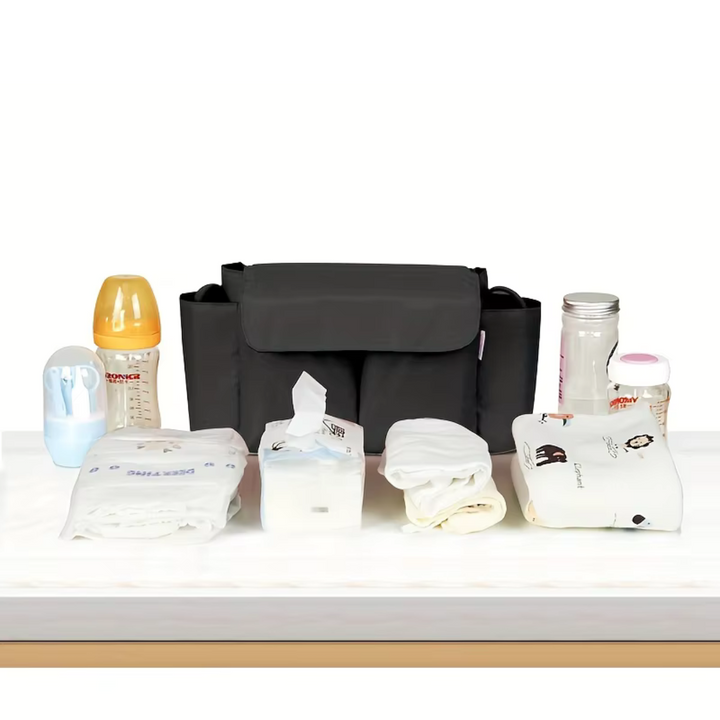 Black stroller organizer displayed with bottles, wipes, diapers, and other baby essentials