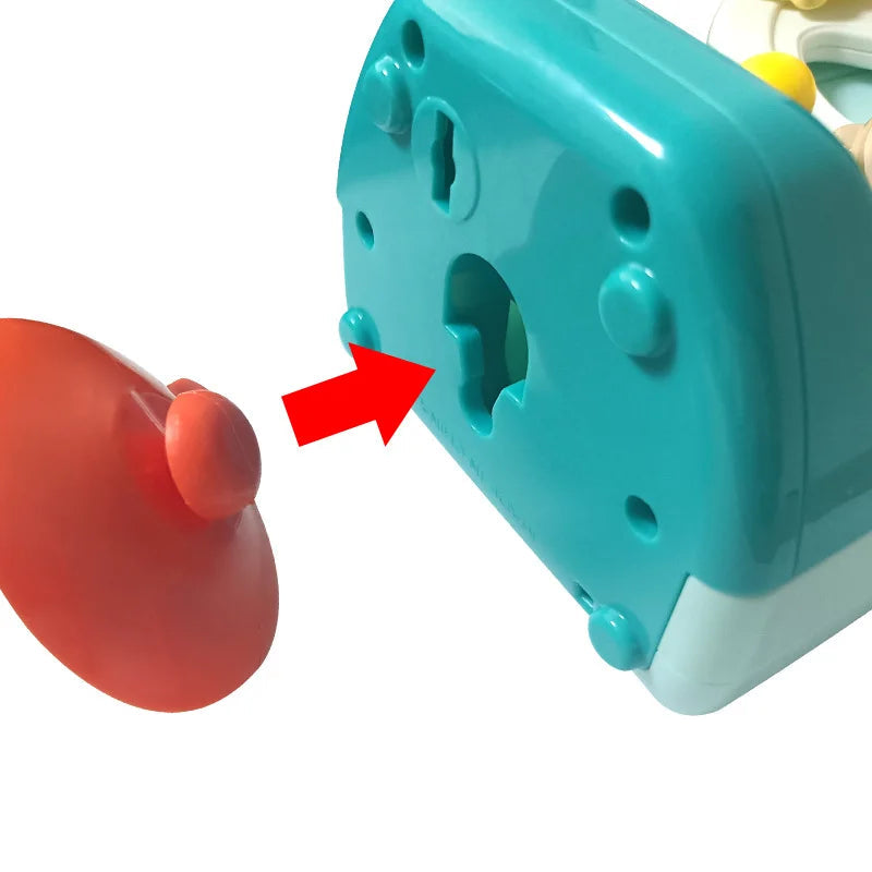 Close-up of the suction cup and its attachment point underneath the blue music box