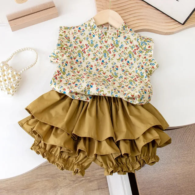 Floral sleeveless top with a tiered mustard skirt arranged as a two-piece outfit
