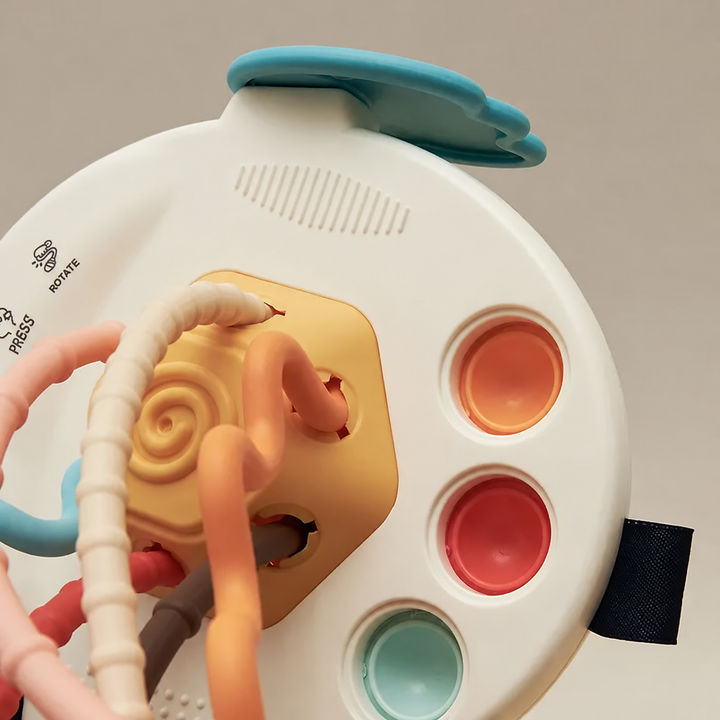 Back of the swan-style sensory toy with colored buttons and textured pull cords