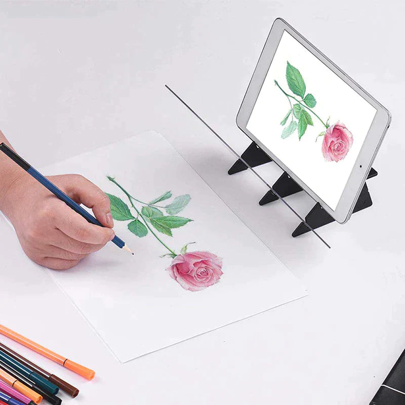 Tablet showing a rose while a hand draws the flower beside the clear tracing panel