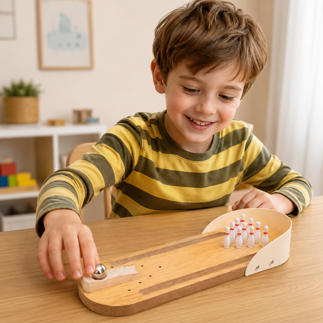 Child lining up a metal bowling ball on the wooden tabletop lane