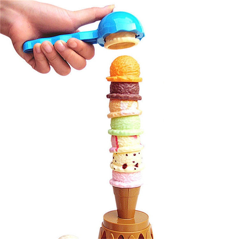 A hand using a blue scoop above a tall stack of colorful toy ice cream pieces