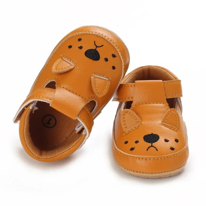 Tan cat-face baby shoes with whisker details and pointed ears