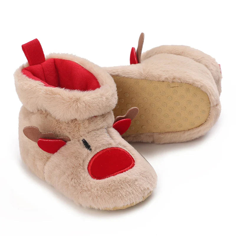 Tan reindeer baby slippers with one turned over to show the dotted sole