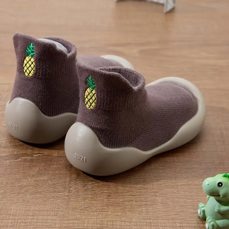 Taupe-brown baby shoes with pineapple motifs and pale rubber soles