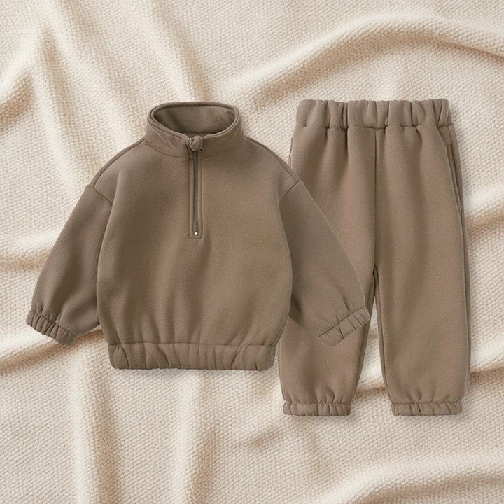 Taupe quarter-zip sweatshirt and matching joggers on a textured blanket